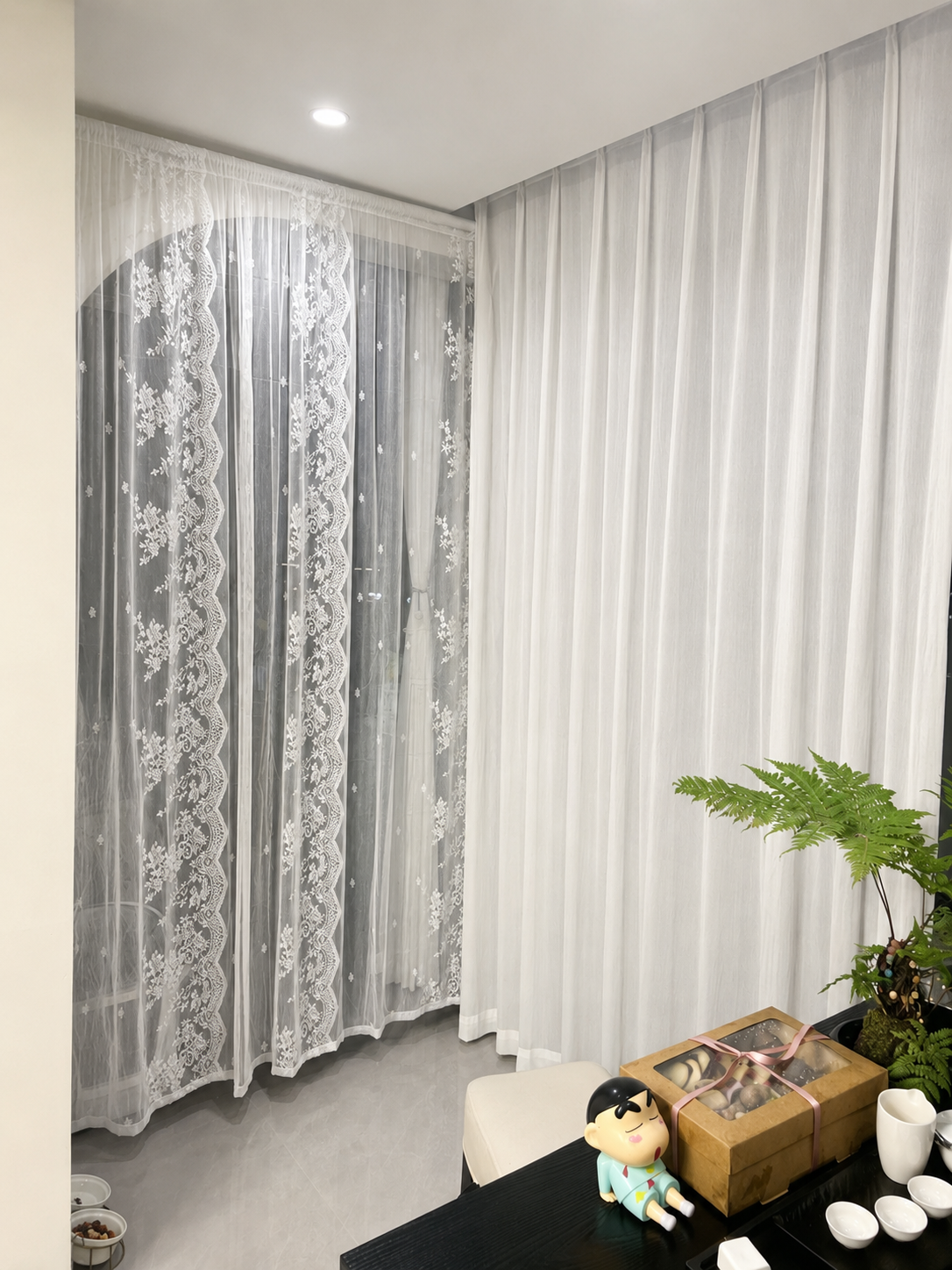 Coordinated lace and sheer curtains across a residential room